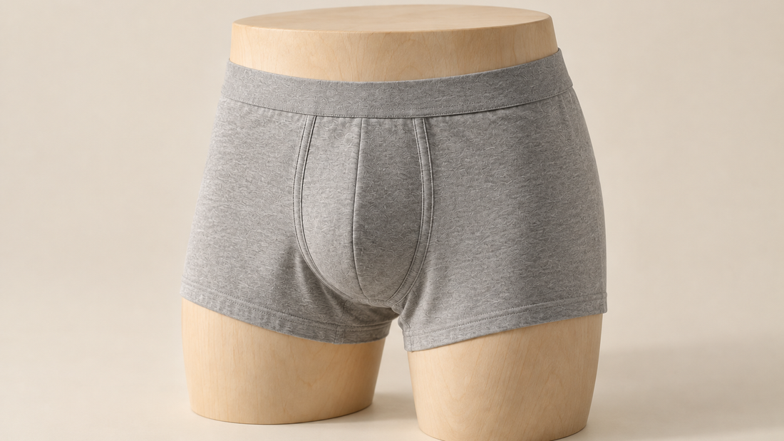 Cotton trunk fitted on a mannequin hip form, showing the curved front panel seams and flat leg openings that make underwear supportive