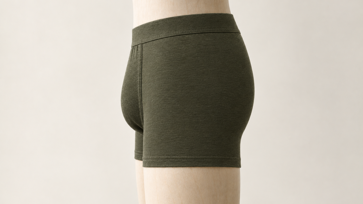 Side view of an olive cotton trunk on a mannequin, showing where the leg hem sits on the thigh