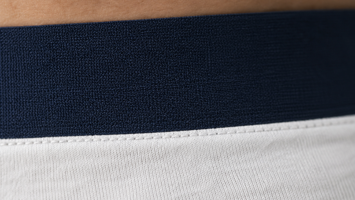 Close-up of a wide flat woven waistband on a men's cotton trunk.